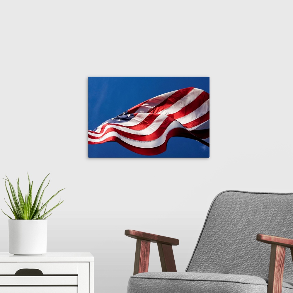 A modern room featuring USA, Washington, Cashmere, View from below large American flag flying outside roadside candy stan...
