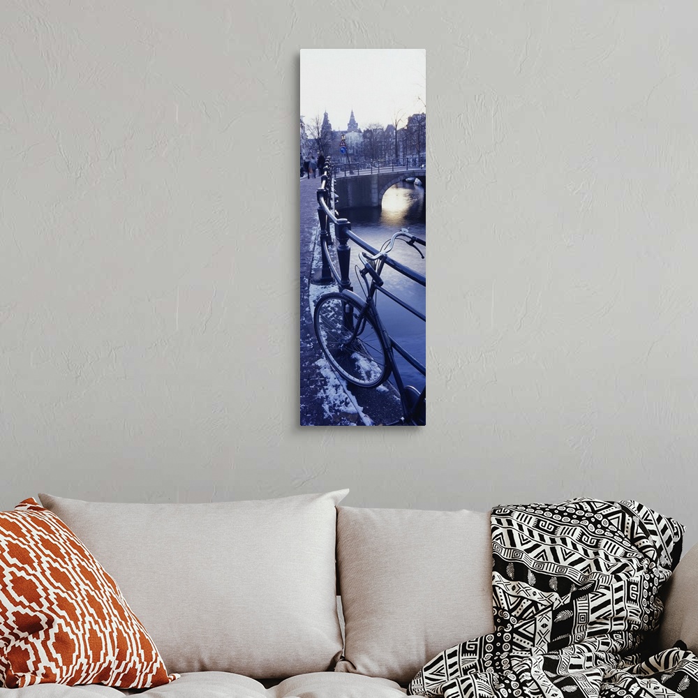 A bohemian room featuring Amsterdam, Holland - bicycle standing at railings on canal bank