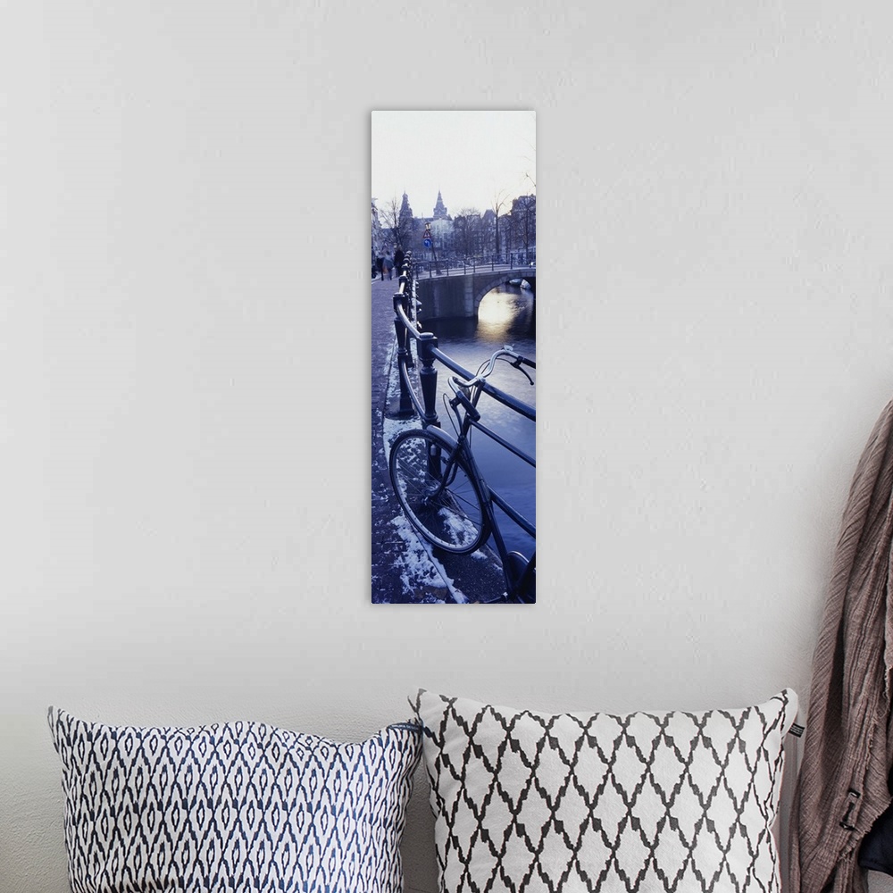 A bohemian room featuring Amsterdam, Holland - bicycle standing at railings on canal bank