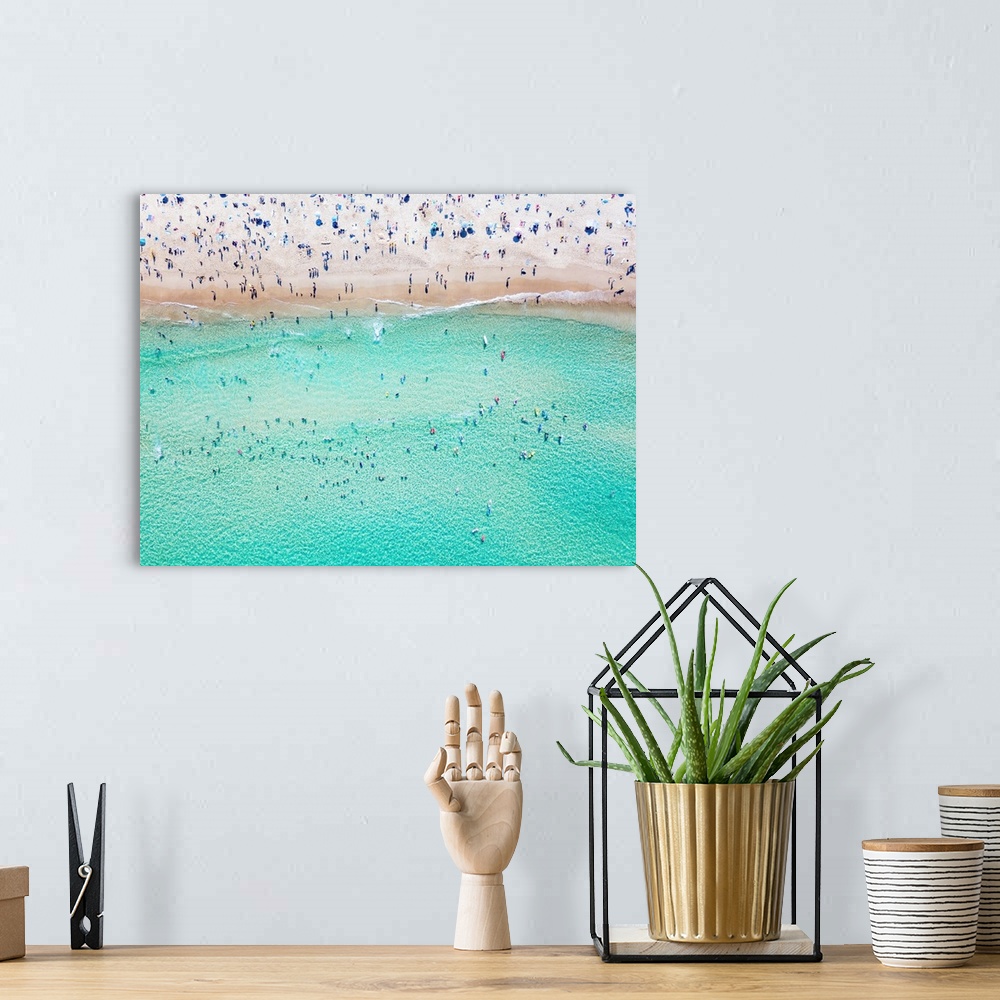 A bohemian room featuring An aerial view of people at the beach. An aerial view looking down at Bondi beach in Sydney on a ...