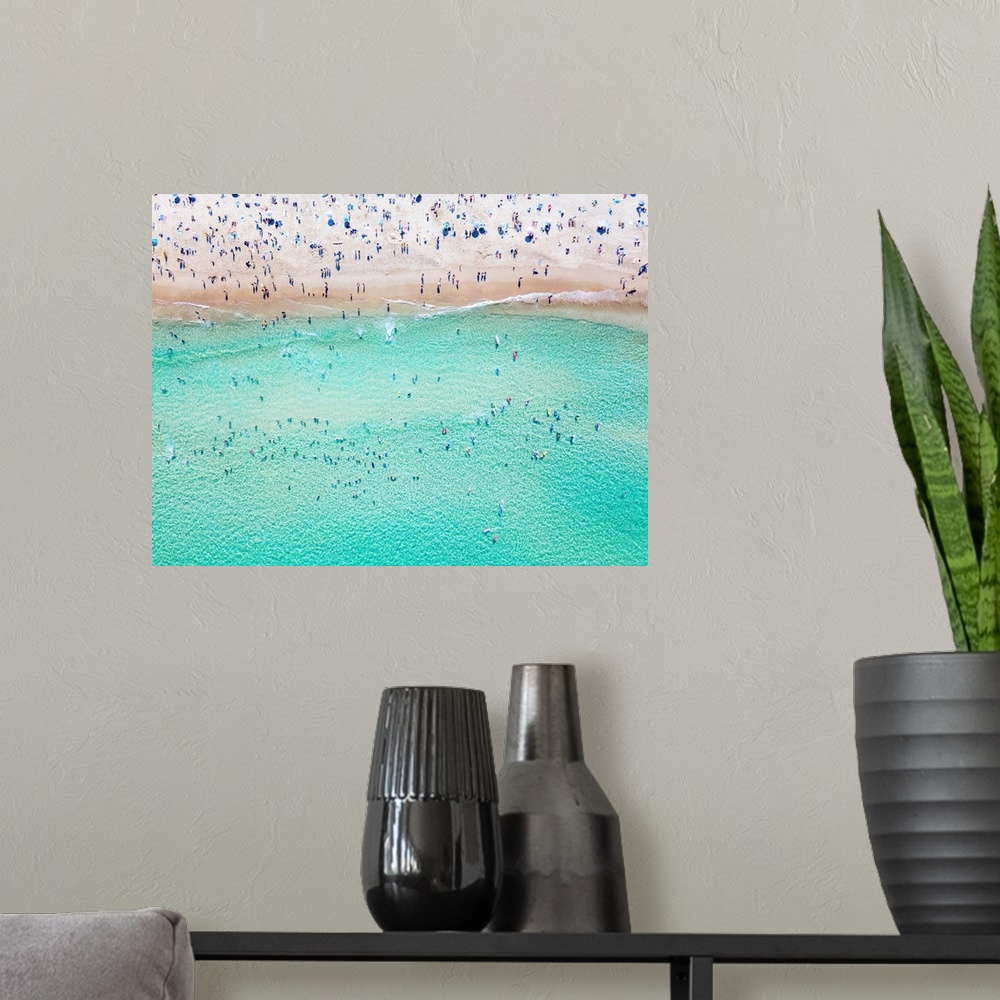 A modern room featuring An aerial view of people at the beach. An aerial view looking down at Bondi beach in Sydney on a ...