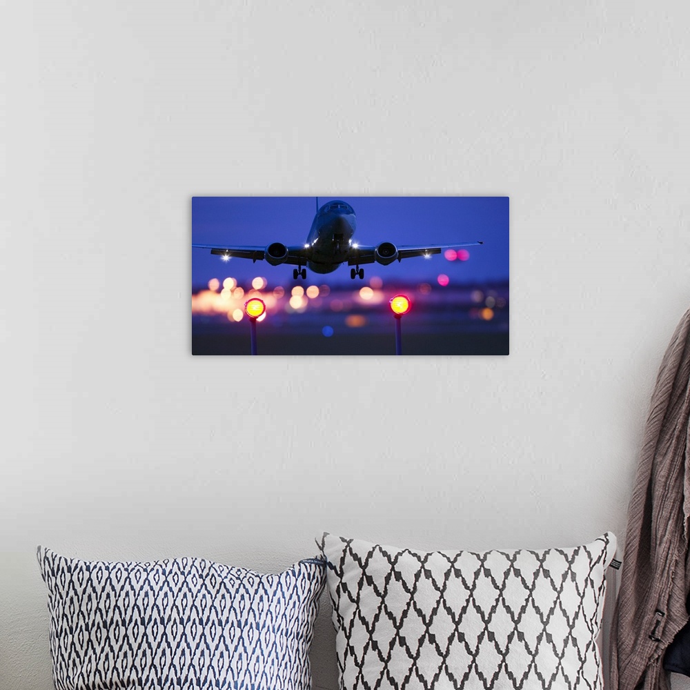 A bohemian room featuring Composite close-up of an airplane landing with blurred lights of the airport in the background
