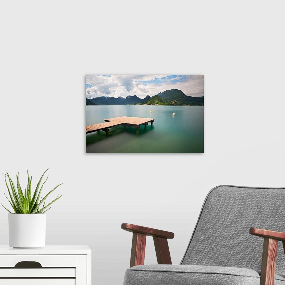 A modern room featuring Annecy lake and French Alps in background.