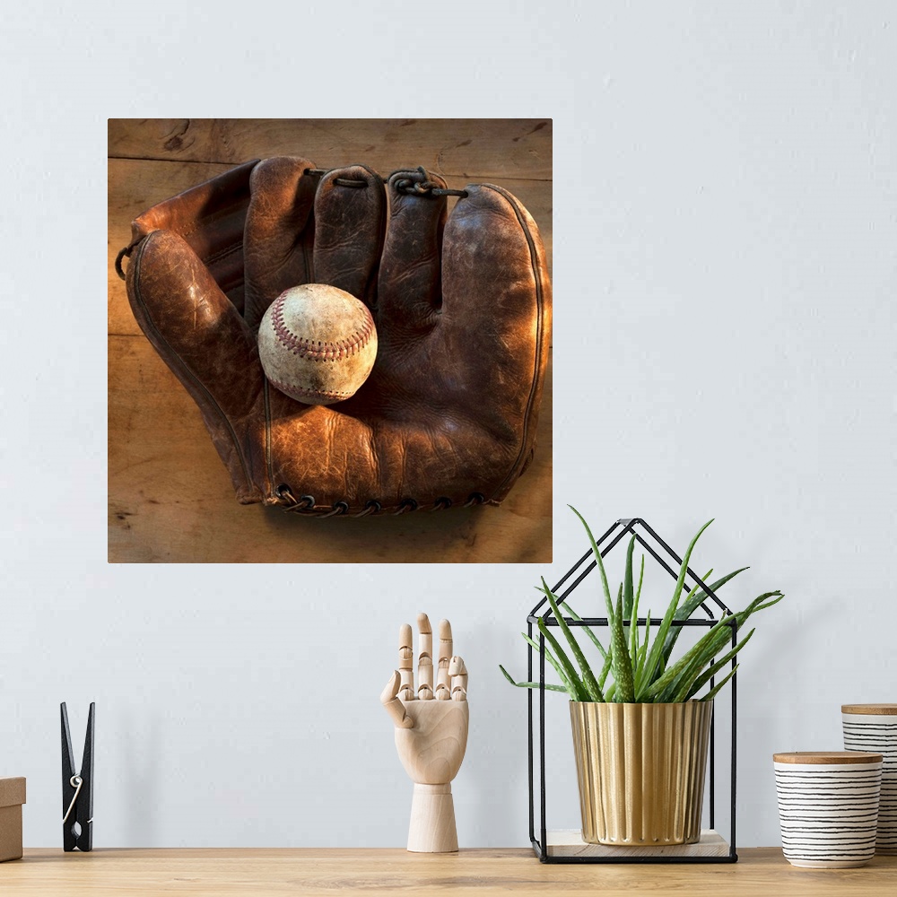 A bohemian room featuring Antique baseball on baseball glove with bat