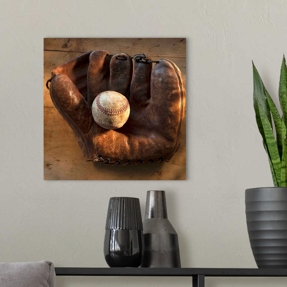 A modern room featuring Antique baseball on baseball glove with bat
