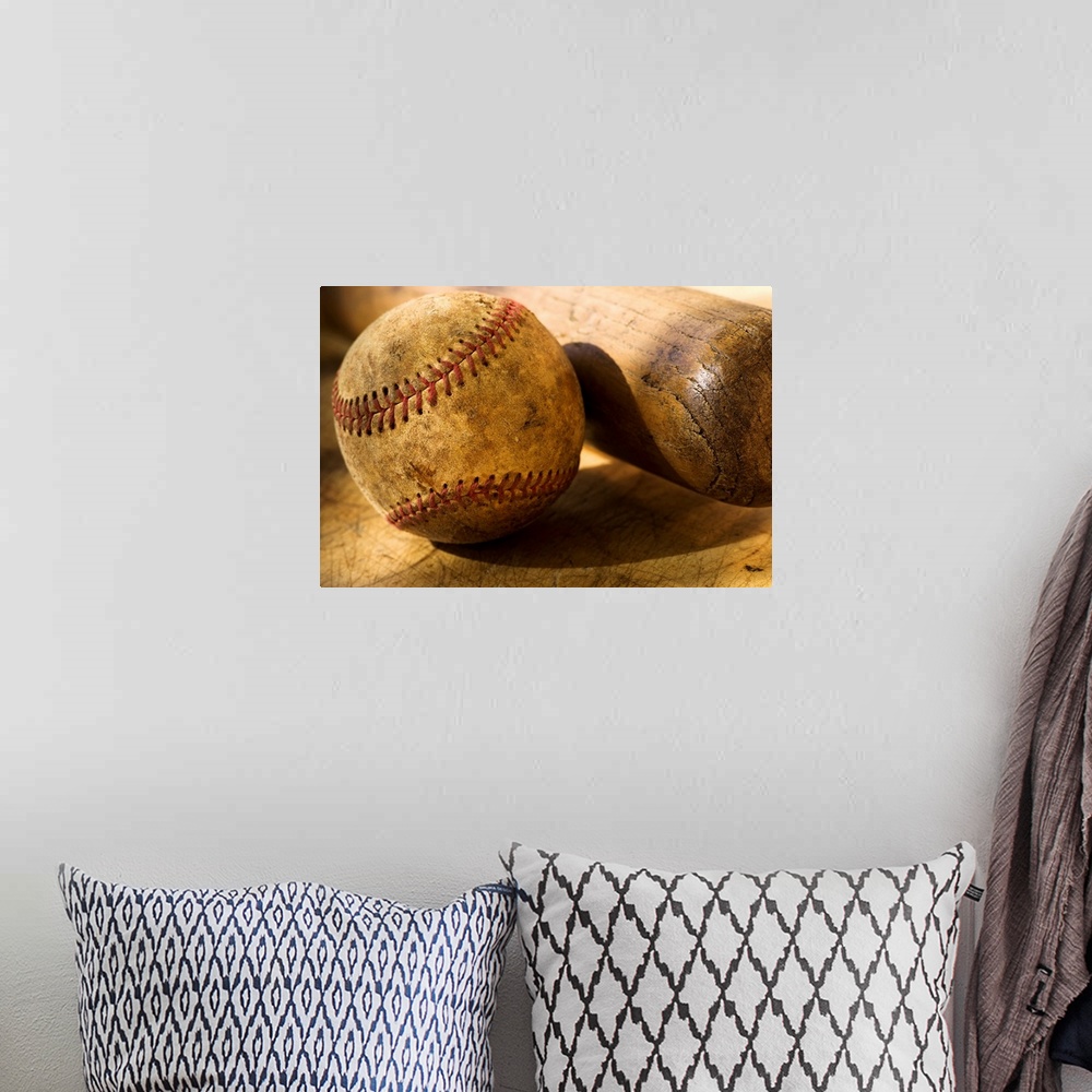 A bohemian room featuring Distressed baseball and bat in this horizontal photograph.
