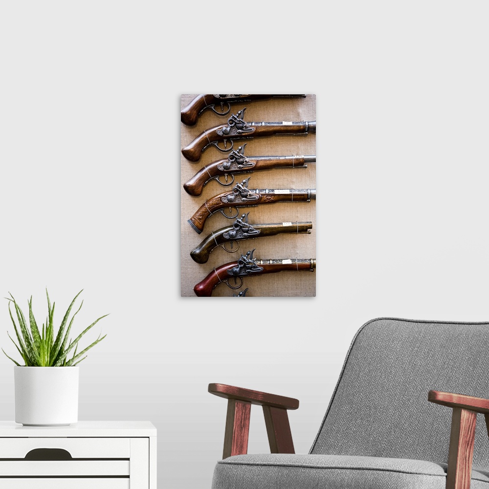 A modern room featuring Antique pistols