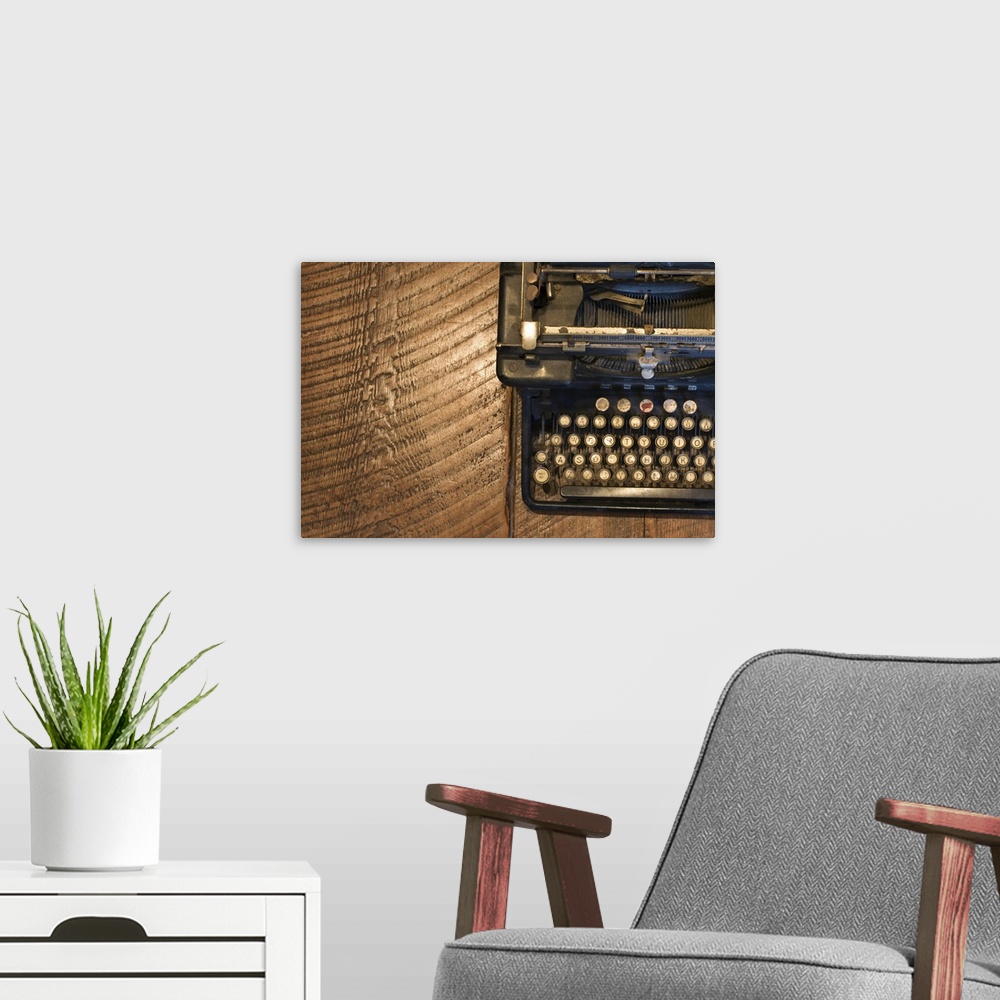 A modern room featuring Antique typewriter on wooden surface