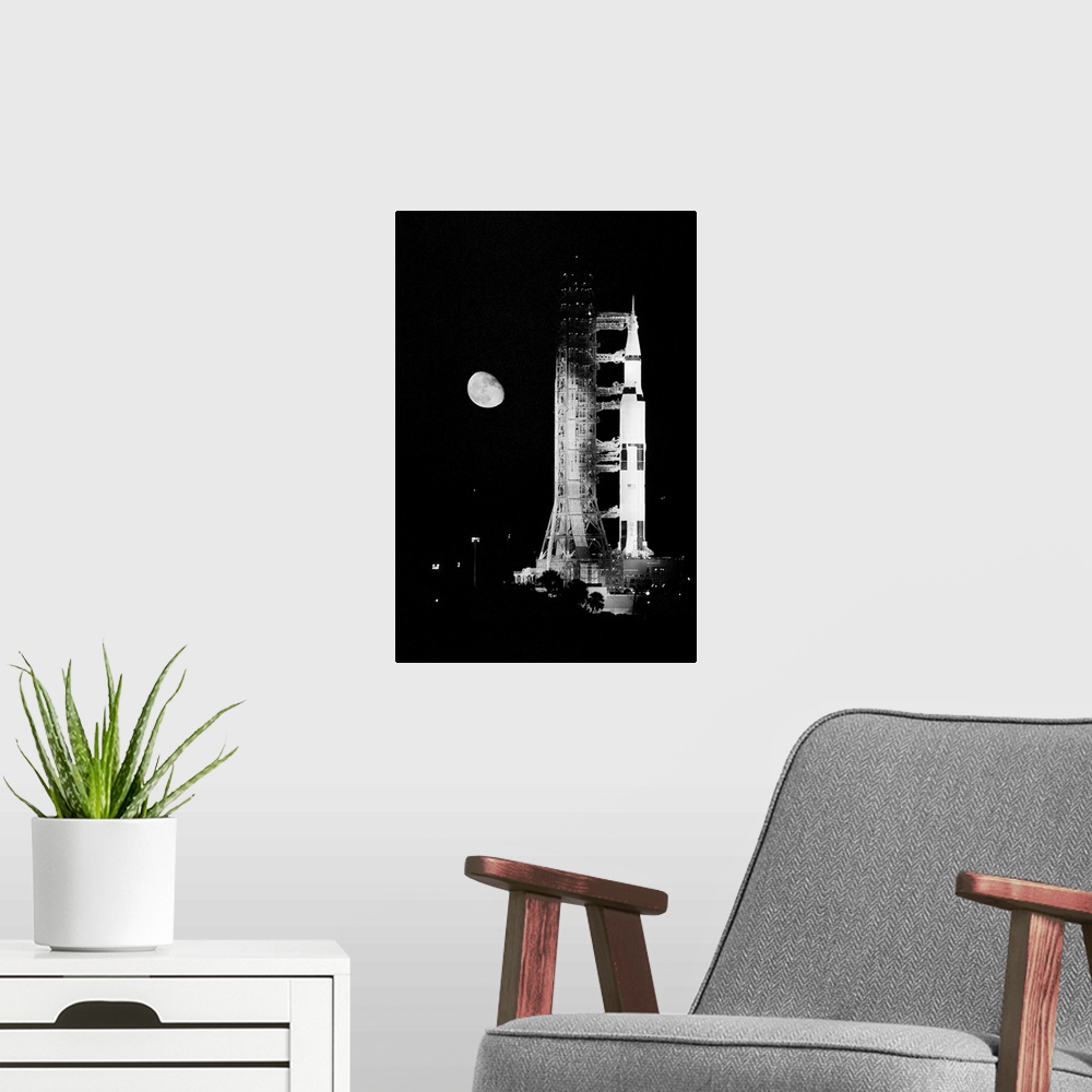 A modern room featuring Kennedy Space Center, Fla. Mounted atop a Saturn 5 rocket, the Apollo 11 spacecraft in which Neil...
