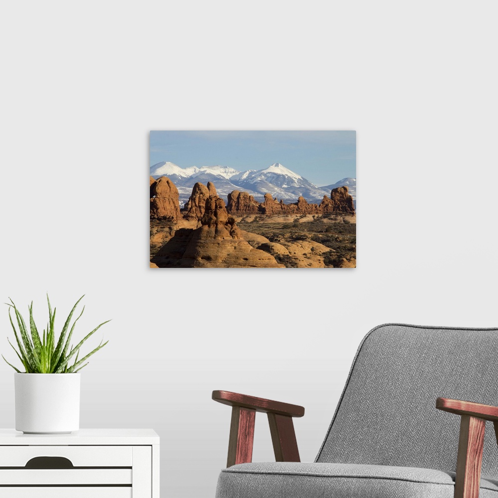 A modern room featuring The snow-capped montains of the La Sal Mountain range is visible in the background.