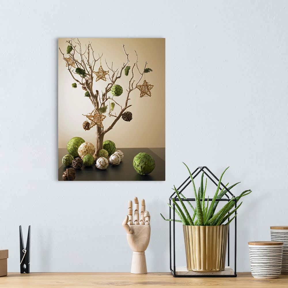 A bohemian room featuring Artwork composed from dried tree branch and paper ornaments