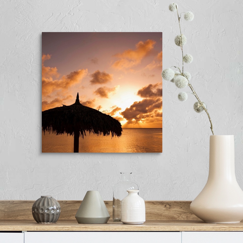 A farmhouse room featuring Aruba, silhouette of palapa on beach at sunset