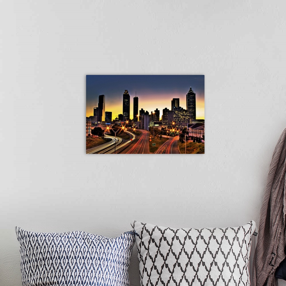 A bohemian room featuring Atlanta colorful skyline with sun setting in background.