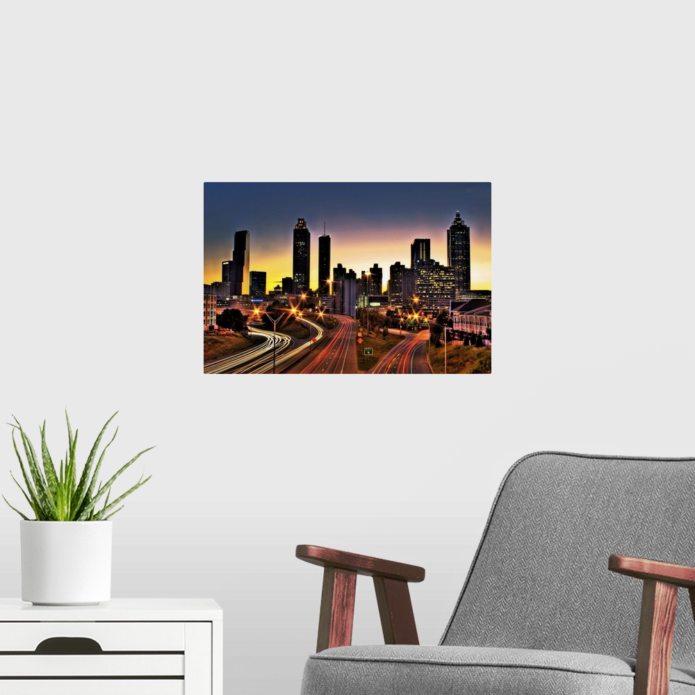A modern room featuring Atlanta colorful skyline with sun setting in background.