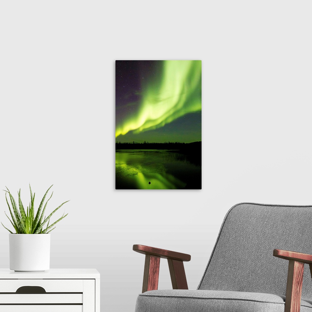 A modern room featuring Aurora borealis (northern lights) dance above Prosperous Lake outside of Yellowknife, Canada in e...