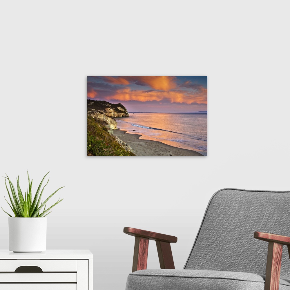 A modern room featuring Horizontal photograph on a big wall hanging of the rocky coast line along Avila Beach in Californ...
