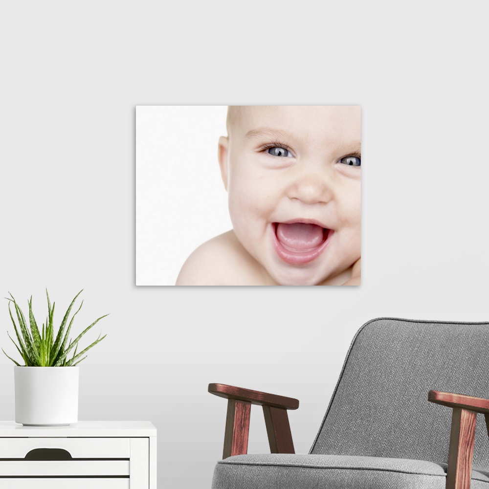 A modern room featuring Baby boy (6-9 months) laughing, close up, portrait, studio shot