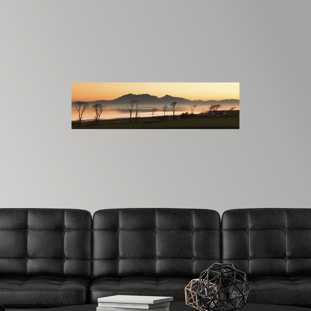 A modern room featuring Bare trees at west coast with mountain in background at Scotland.