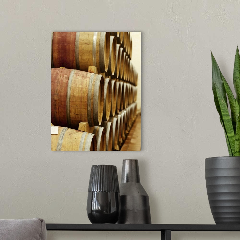 A modern room featuring barrels of wine in a warehouse