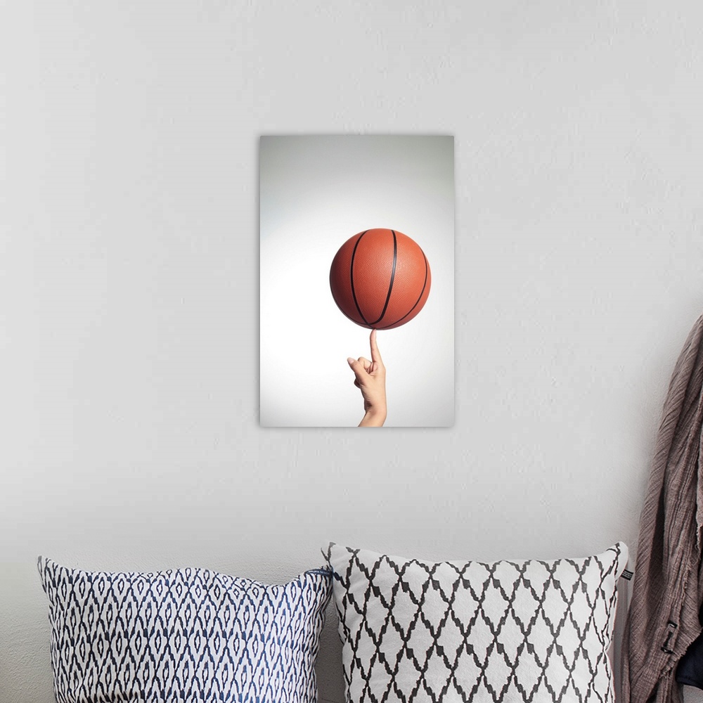 A bohemian room featuring Basketball on index finger,hands close-up