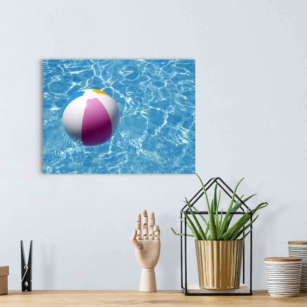 A bohemian room featuring Beach ball in swimming pool the picture of summer holidays.