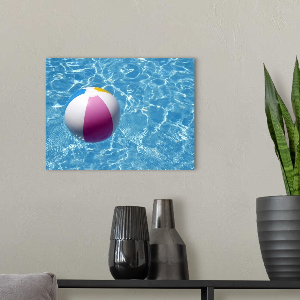 A modern room featuring Beach ball in swimming pool the picture of summer holidays.