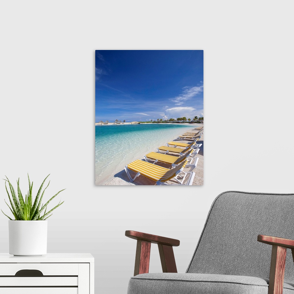 A modern room featuring Beach lawn chairs tropical water