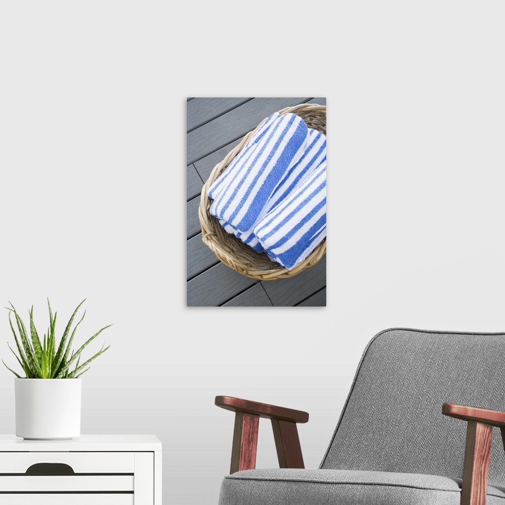 A modern room featuring Beach towels in basket
