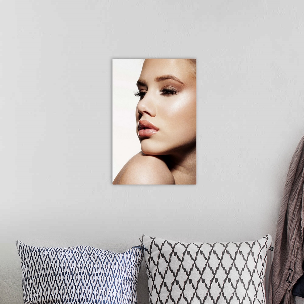 A bohemian room featuring Close-up of young female face, beauty portrait, blue eyes, clear skin, professional make-up.