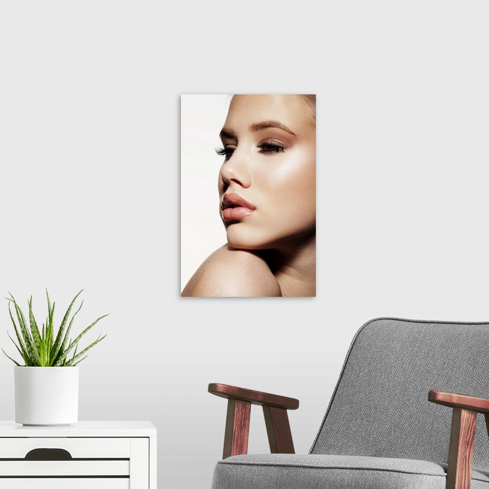 A modern room featuring Close-up of young female face, beauty portrait, blue eyes, clear skin, professional make-up.