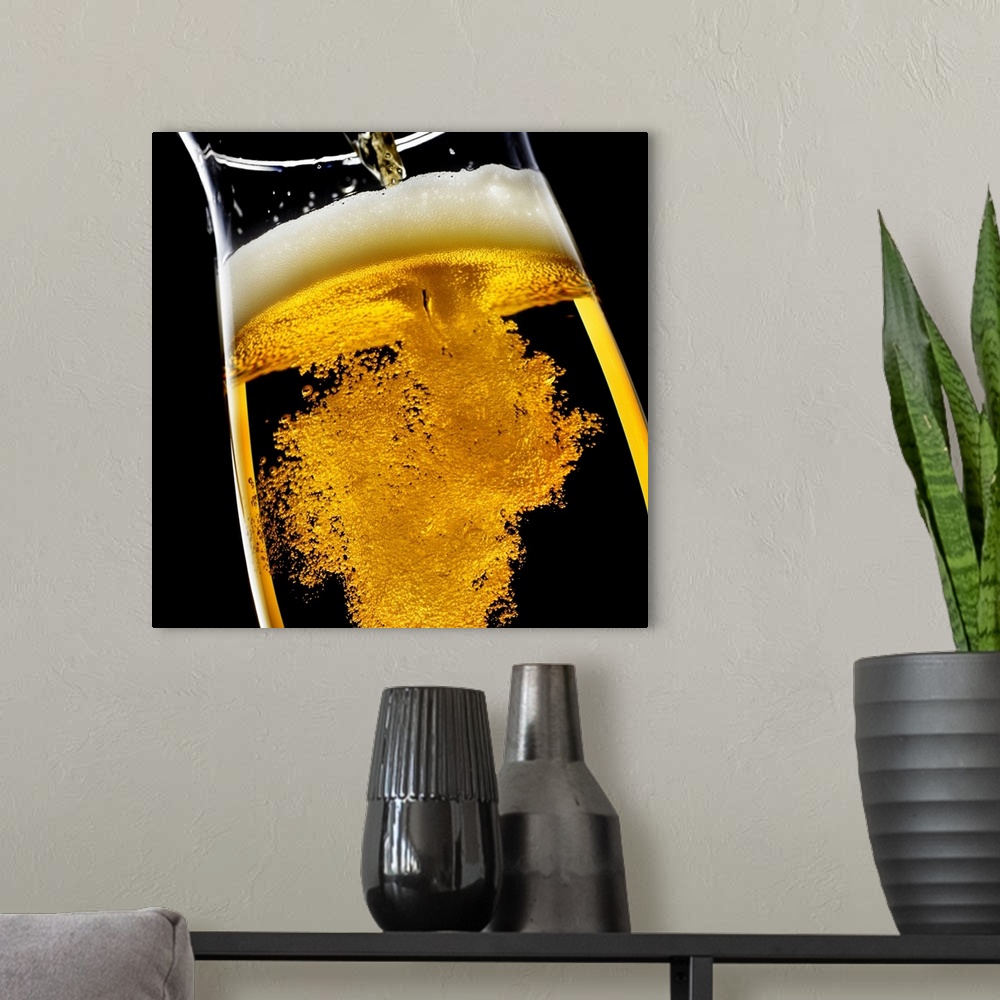 A modern room featuring Beer been poured into glass, studio shot
