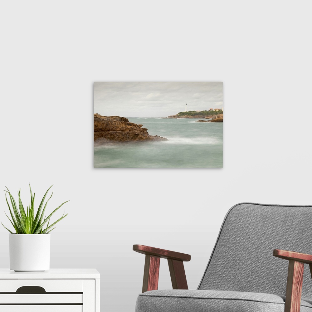 A modern room featuring Biarritz Lighthouse with rocks and sea.