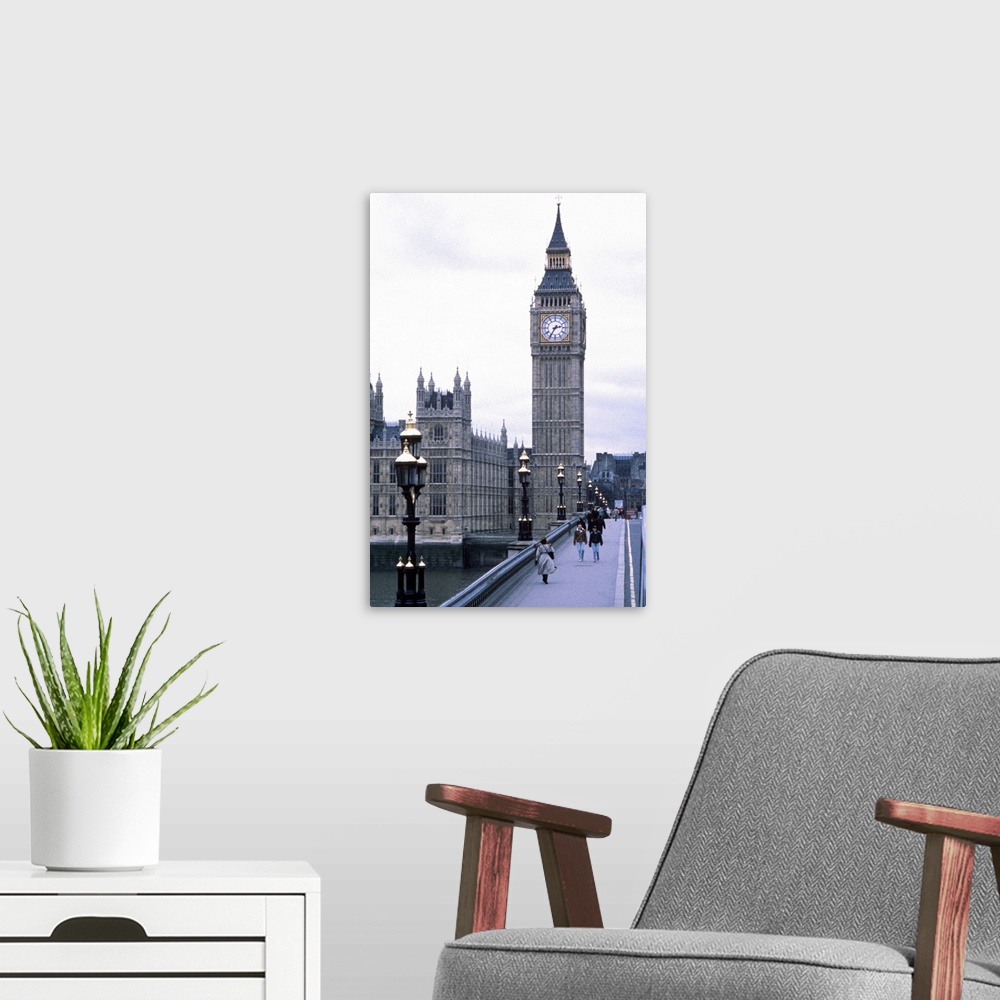 A modern room featuring Portrait, large photograph of people walking on Westminster Bridge, leading toward Big Ben toweri...