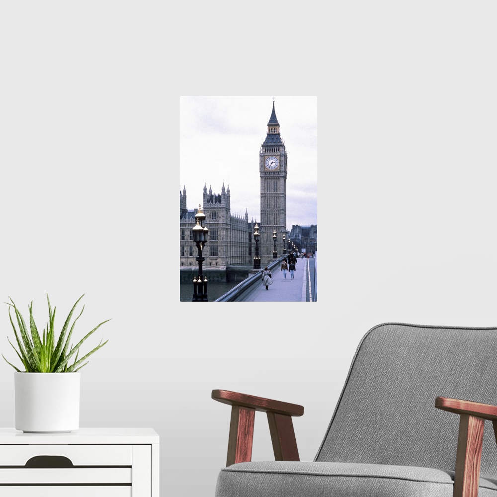 A modern room featuring Portrait, large photograph of people walking on Westminster Bridge, leading toward Big Ben toweri...