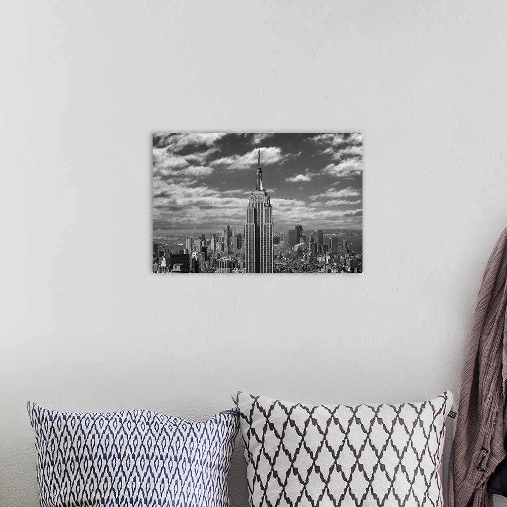A bohemian room featuring Black and white landscape photograph taken of the Empire State building with the skyline seen in ...