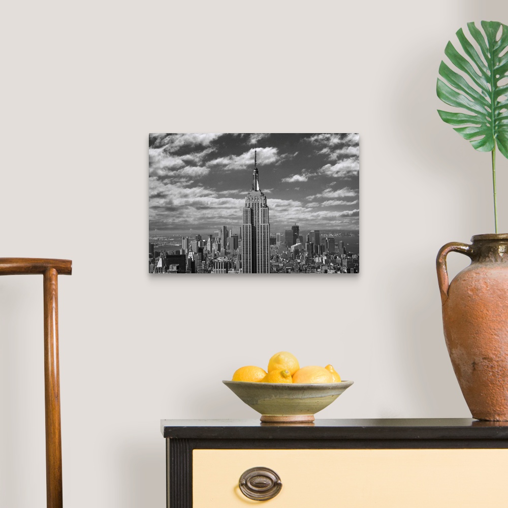 A traditional room featuring Black and white landscape photograph taken of the Empire State building with the skyline seen in ...