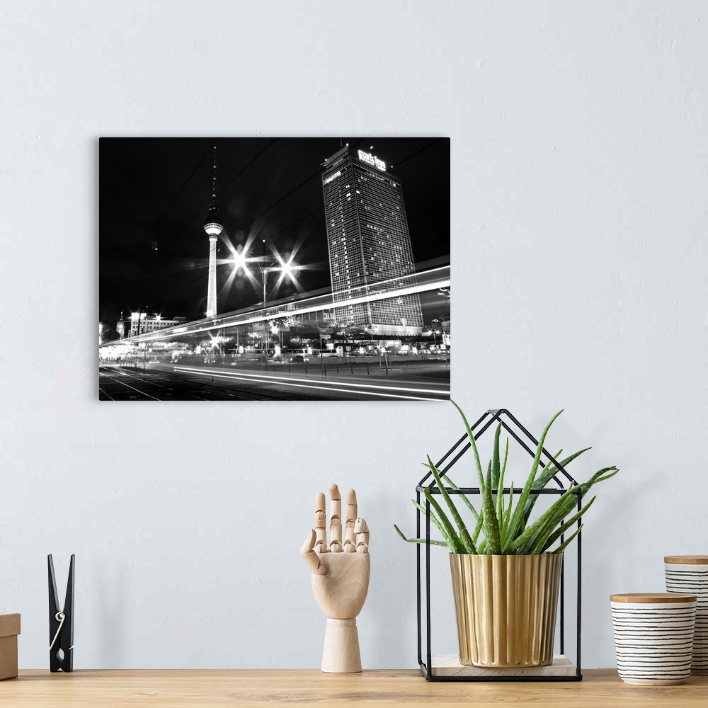A bohemian room featuring Black and white image of cityscape in night.