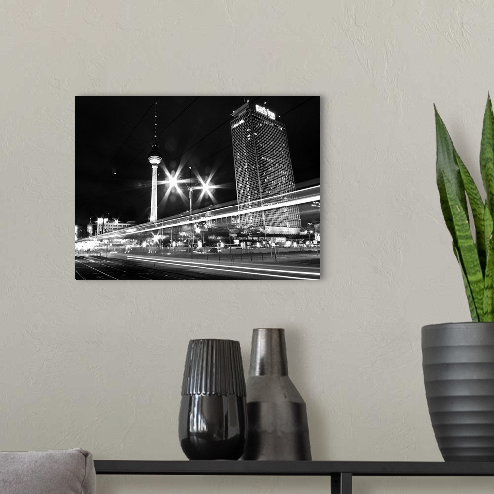 A modern room featuring Black and white image of cityscape in night.