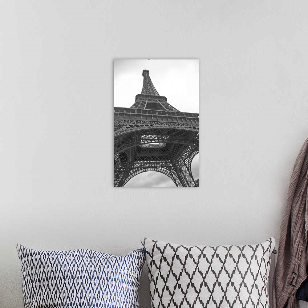 A bohemian room featuring Black and white photograph of the Eiffel Tower looking up from underneath with dove flying above.