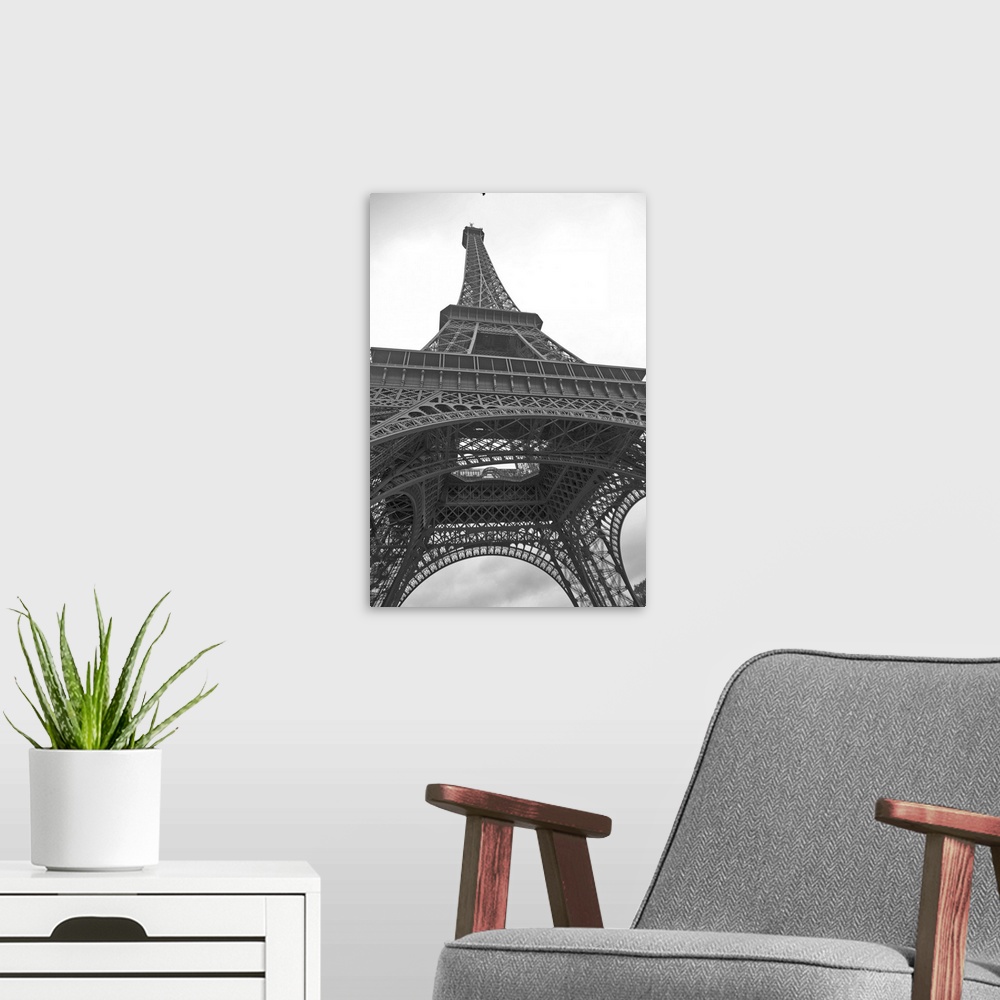 A modern room featuring Black and white photograph of the Eiffel Tower looking up from underneath with dove flying above.
