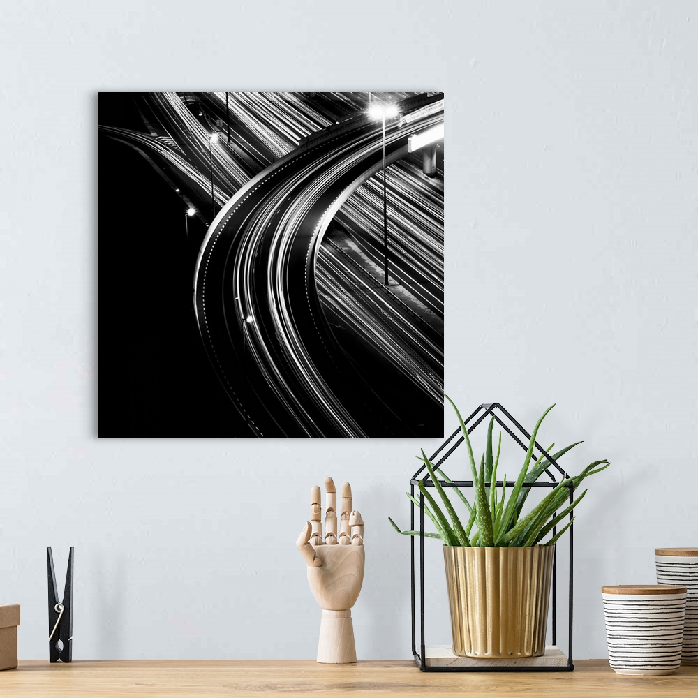 A bohemian room featuring Black and white shot of multiple light trails of an overpass in Dubai city.