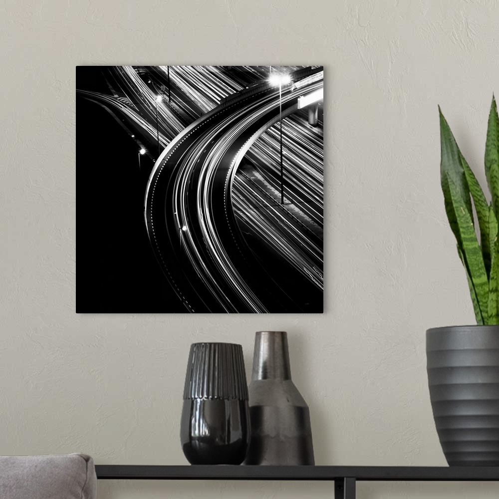 A modern room featuring Black and white shot of multiple light trails of an overpass in Dubai city.