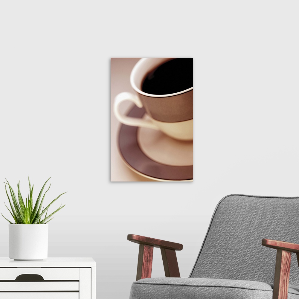 A modern room featuring Black coffee in brown and white cup