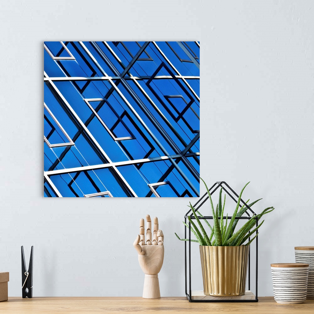A bohemian room featuring Blue, abstract and geometric reflection on  facade of modern building.