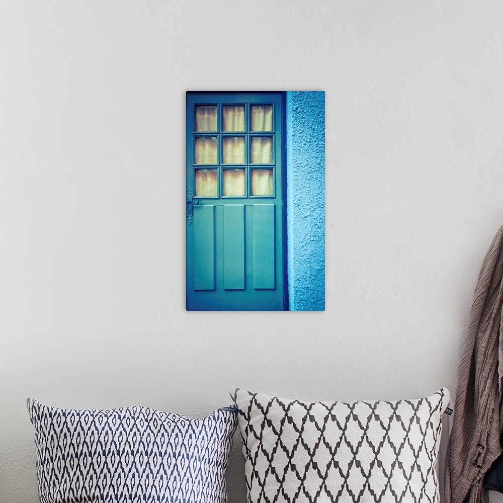 A bohemian room featuring Blue door with blue wall.
