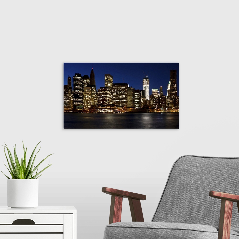 A modern room featuring Skyline of lower Manhattan from Brooklyn bridge park in early evening.