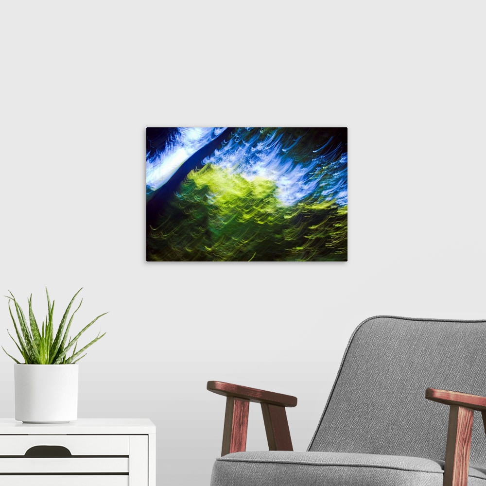 A modern room featuring Blue sky seen from inside forest. Blurred motion. Sunlight on green leaves. Painterly effect. Cou...