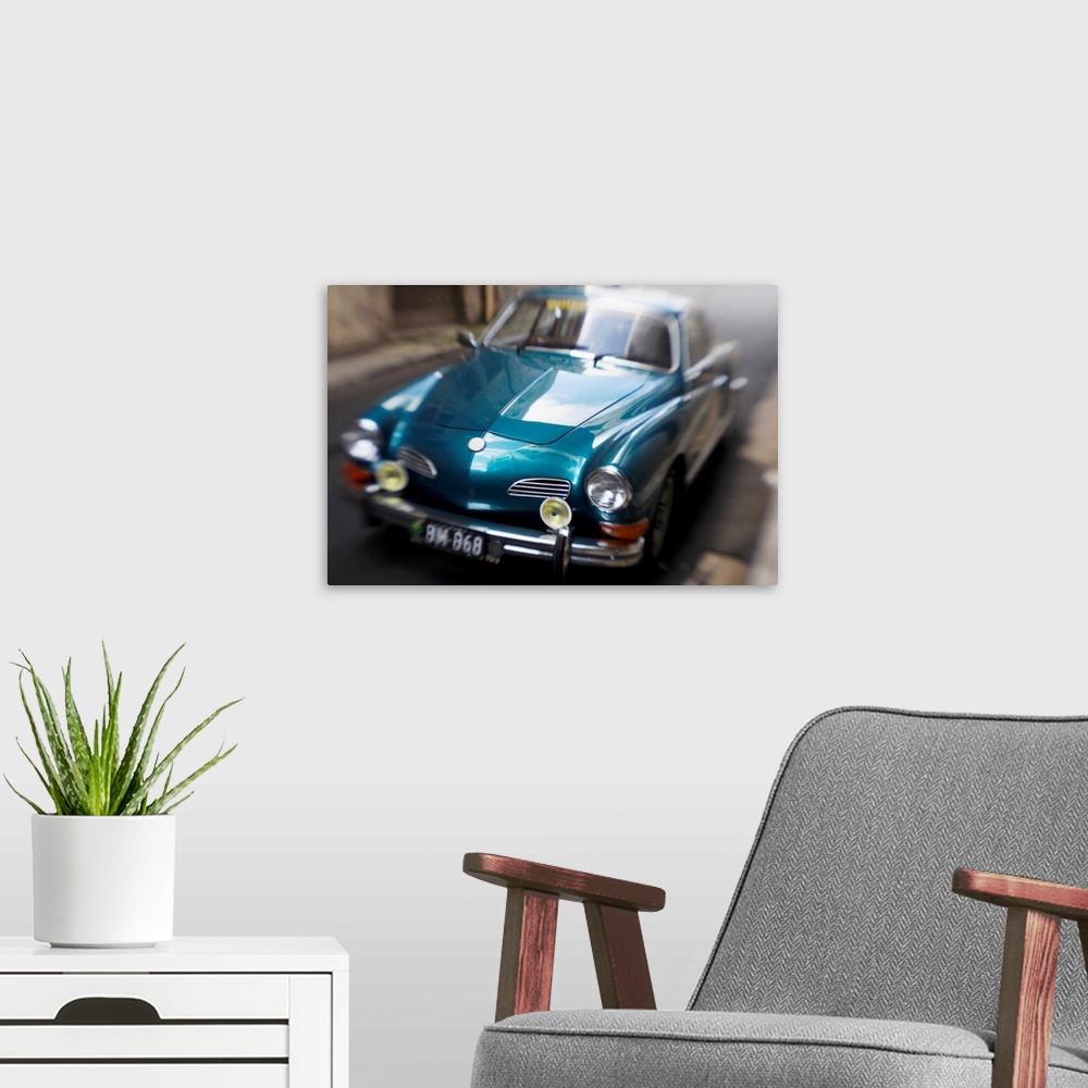 A modern room featuring Blurred Motion Shot of a Metallic Blue Classic Car