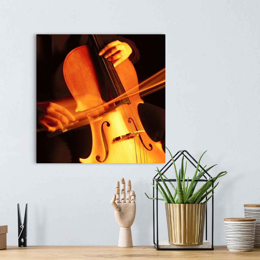 A bohemian room featuring blurred shot of a person playing the cello