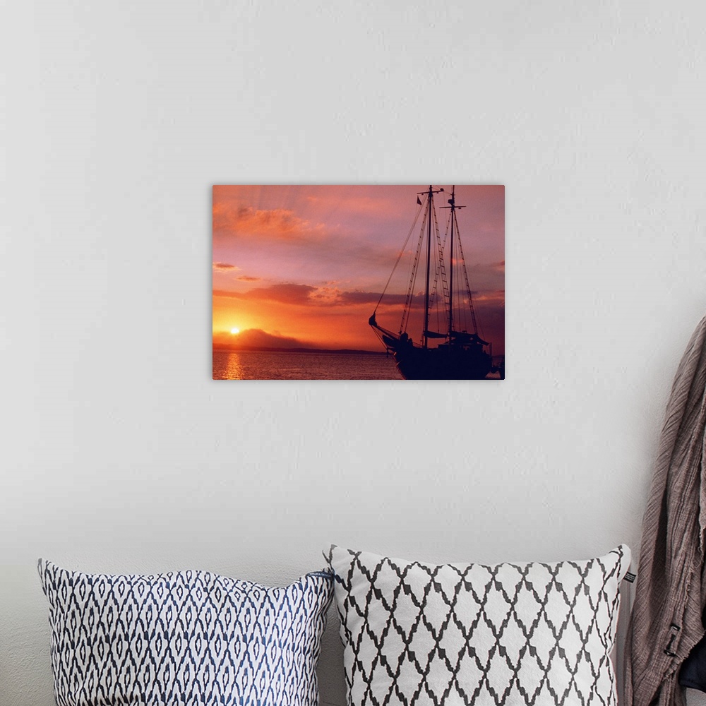A bohemian room featuring boat at sunset